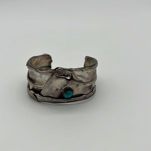 Sterling silver bracelet with turquoise stone.